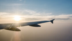 airplane wing and sunset on blue sky